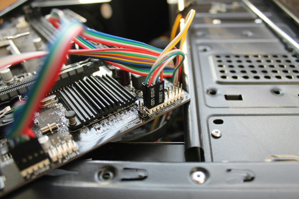 pexels-photo-6663191-6663191 Close-up view of a motherboard with colorful wires and electronic components, showcasing intricate details.